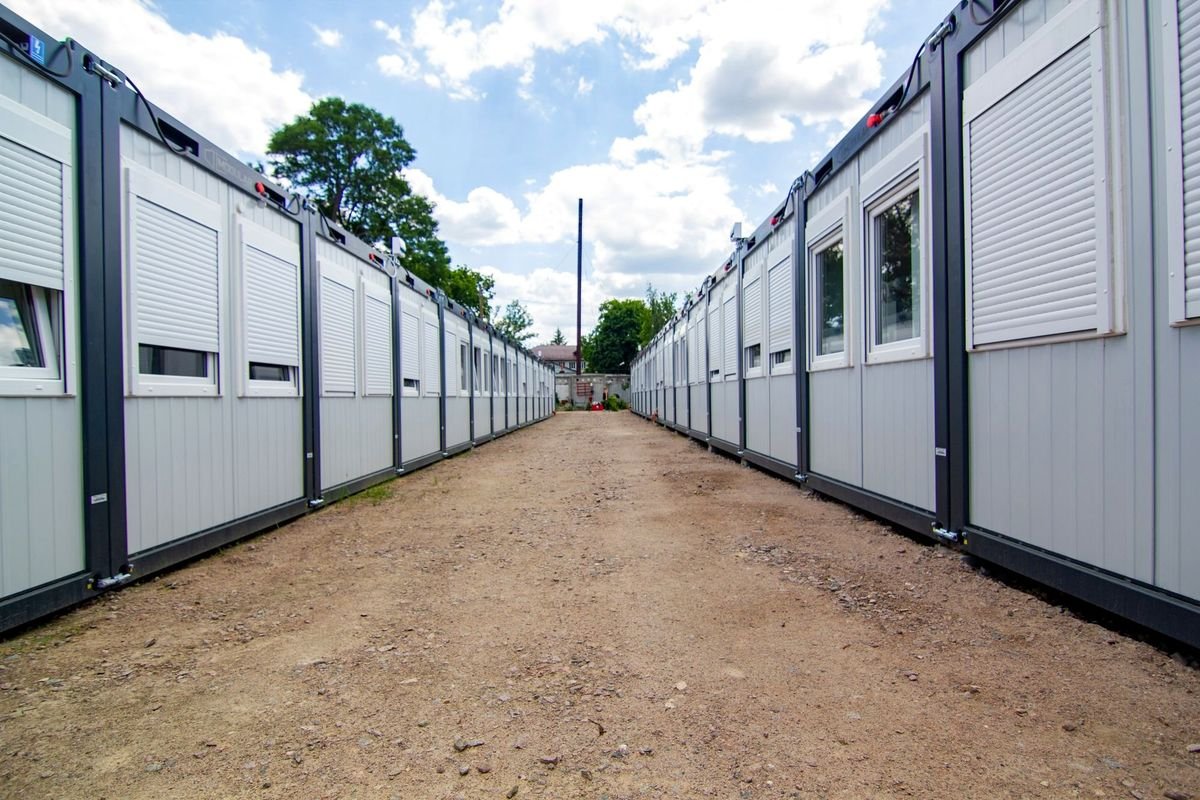 Access road between rows of accommodation cabins at a site camp