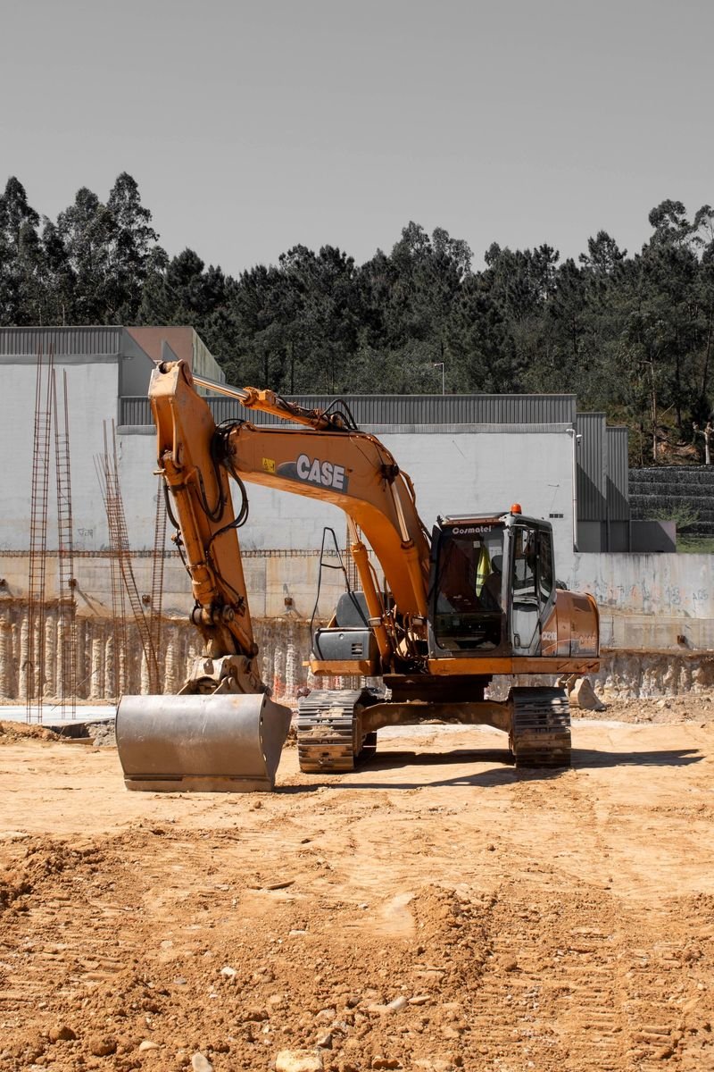 Excavator beside reinforced concrete columns