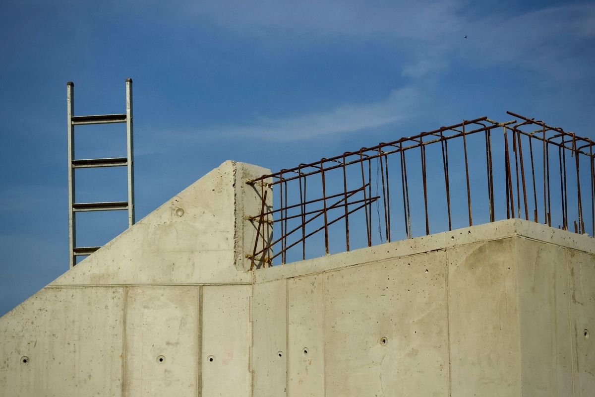 Finished concrete structure with reinforcement starter bars