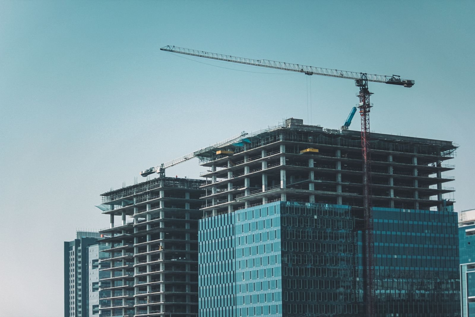 High-rise towers under construction with a tower crane