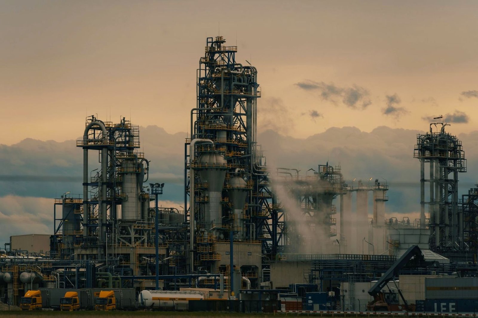 Refinery towers silhouetted at dusk