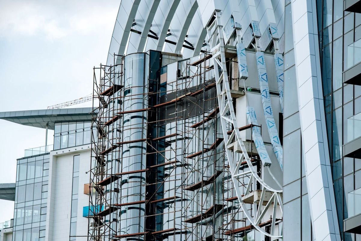 Scaffolding erected against a modern glazed facade
