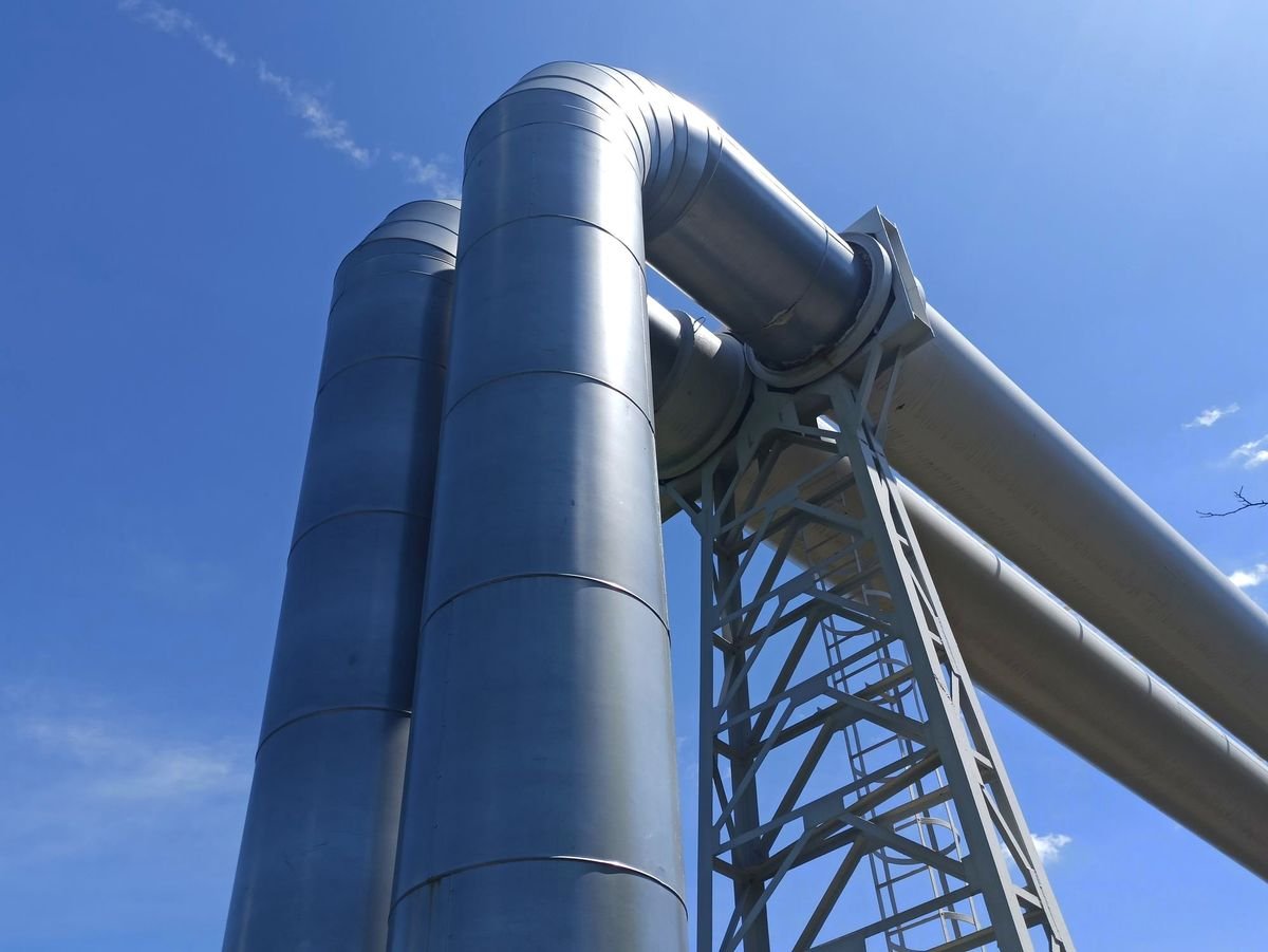 Stacked steel pipes at an industrial supply yard